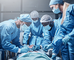 Image showing Doctors, surgery and collaboration with a medicine team in scrubs operating on a man patient in a hospital. Doctor, nurse and teamwork with a medical group in a clinic to perform an operation