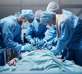 Image showing Doctors, surgery and collaboration with a medicine team in scrubs operating on a man patient in a hospital. Doctor, nurse and teamwork with a medical group in a clinic to perform an operation