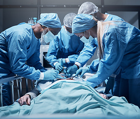 Image showing Doctors, surgery and collaboration with a medicine team in scrubs operating on a man patient in a hospital. Doctor, nurse and teamwork with a medical group in a clinic to perform an operation