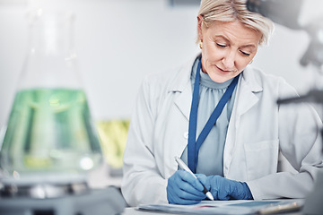 Image showing Science, research and senior woman writing notes on documents in laboratory. Innovation, thinking and elderly female scientist researching, recording and write experiment results, analysis or report.