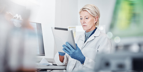 Image showing Tablet, thinking and science with a doctor woman at work in a lab for research, innovation or development. Healthcare, medical and idea with a senior female scientist working in a laboratory