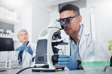 Image showing Science, microscope and innovation with a doctor man in a laboratory for research or medical development. DNA, healthcare and medicine with a male scientist working in a lab for sample analysis