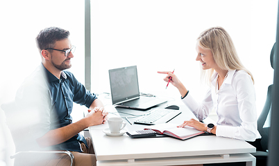 Image showing Business meeting. Client consulting. Confident business woman, real estate agent, financial advisor explaining details of project or financial product to client in office.