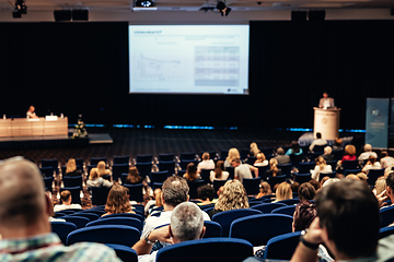 Image showing Speaker giving a talk on scientific conference. Audience at the conference hall. Business and Entrepreneurship concept.