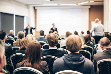 Image showing I have a question. Group of business people sitting in conference hall. Businessman raising his arm. Conference and Presentation. Business and Entrepreneurship