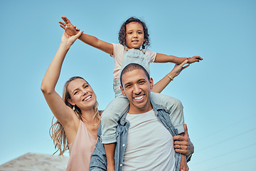 Image showing Family, children and piggyback with a girl sitting on the shoulders of her father while mother is outdoor together. Interracial, kids and love with a man, woman and daughter bonding outside in summer