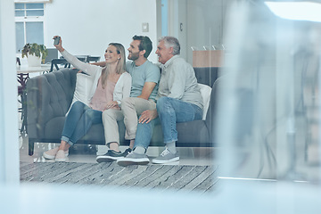 Image showing Selfie, phone and happy family on a sofa in the living room relaxing and bonding in their modern home. Happiness, love and young couple taking a picture on a cellphone with a senior man in a lounge.