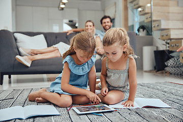 Image showing Living room, parents relaxing and children doing elearning on tablet in books on the floor in their home. Mother, father and girl kids sitting in lounge together for homeschool learning and studying.