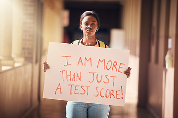 Image showing Education, protest and student with a poster at a college for scholarship, debt and school loans. Justice, freedom and black woman standing with a sign on the university, school or academic campus.