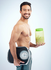 Image showing Man, diet or body protein powder on blue studio background in weight loss, bodybuilding or Japanese muscle growth. Portrait, smile or happy athlete with weight scale or healthcare wellness supplement