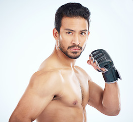 Image showing Face portrait, mma sports and man in studio on a blue background. Martial arts, body fitness and serious male fighter or boxer ready for training, workout or exercise for battle, match or competition