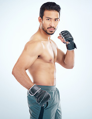 Image showing Face portrait, mma sports and man in studio on a blue background. Martial arts, body fitness and serious male fighter or boxer ready for training, workout or exercise for battle, match or competition