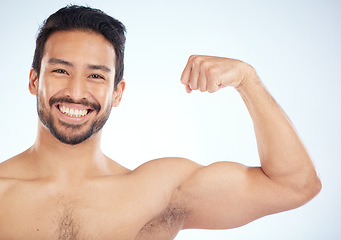 Image showing Portrait, fitness or man in studio to flex muscle or strong arms training biceps in workout or exercise. Face, happy smile or healthy bodybuilder with growth mindset, motivation or wellness goals