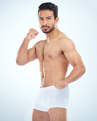 Image showing Fitness, underwear and man with fist, studio or martial arts with muscle, wellness and strong by backdrop. Model, mma and shirtless with balance, posture and portrait by studio background with focus