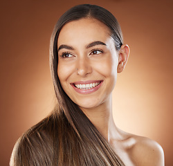 Image showing Hair, beauty and skincare with a model woman in studio on a brown background for natural or keratin treatment. Face, haircare and salon with an attractive young female posing to promote a product