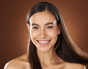 Image showing Hair, beauty and portrait of woman in studio for wellness, hair treatment and shampoo products. Hair salon, hair care aesthetic and girl face with healthy, natural and long hair on brown background