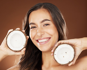 Image showing Face, beauty skincare and woman with coconut in studio on a background. Wellness, organic cosmetics and portrait of female model with fruit, product or food for healthy diet, nutrients or coconut oil