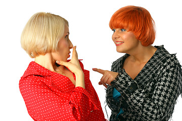 Image showing Two happy young women whispering and surprised