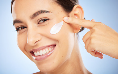 Image showing Portrait, skincare and moisturizer with a model woman in studio on a gray background for antiaging beauty. Face, lotion and product with an attractive young female inside to apply facial treatment