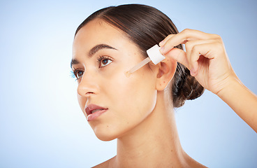 Image showing Face, skincare and woman with serum for beauty in studio on a background. Thinking, cosmetics and female model with hyaluronic acid, essential oil and dropper product for healthy skin and anti aging.