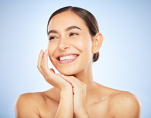 Image showing Woman, face and happy thinking of beauty, skincare wellness or luxury salon spa dermatology on blue background. Facial care vision, happiness and model smile with cosmetics glowing skin in studio