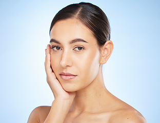Image showing Face portrait, beauty skincare and woman in studio isolated on a blue background. Makeup, natural cosmetics and young female model with glowing, healthy and flawless skin after spa facial treatment.