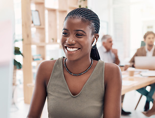 Image showing Music, podcast and woman at computer with earphones in office with streaming service while working. Work, smile and happy black woman listening to streaming radio station app online in modern office.