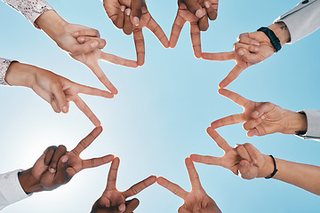 Image showing Team building, blue sky or hands with peace sign for support, teamwork or partnership collaboration. Low angle, trust or fingers showing hope, faith or community group solidarity with mission goals