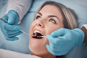 Image showing Dental, teeth and woman at the dentist for a check up, tooth whitening or cavity removal procedure. Dentistry, oral care and hands of a doctor checking the mouth of female patient with medical tools.