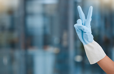 Image showing Hand, peace and mockup with a woman cleaner in an office for hygiene or company housekeeping. Cleaning, job and service with a female housekeeper gesturing a hand sign while in a workplace to clean