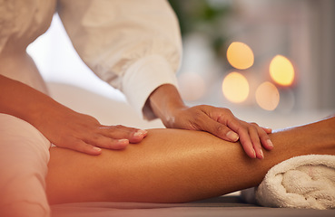 Image showing Spa, hands and legs massage for relax, health and wellness at luxury resort. Zen, physical therapy and woman or female .therapist massaging leg of person on table for skincare, body care and beauty.