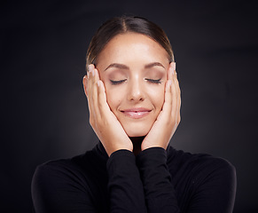 Image showing Face, beauty skincare and woman with eyes closed in studio on a dark background. Makeup, cosmetics and happy female model feeling good with hands on head after spa facial treatment for healthy skin.