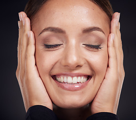 Image showing Face, beauty skincare and woman with eyes closed in studio on a dark background. Makeup, cosmetics and happy female model feeling good with hands on head after spa facial treatment for healthy skin.