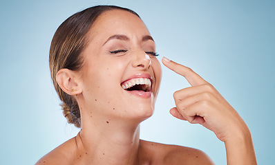 Image showing Skincare, cream and woman with natural care, organic facial or smooth skin on blue studio background. Female, girl and lotion for beauty, cosmetics and wellness for dermatology, smile or makeup creme