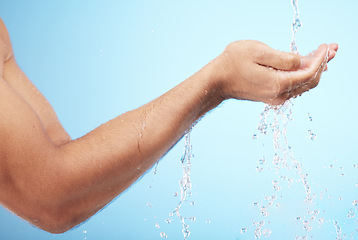 Image showing Man, water or washing hands on blue background for body hygiene maintenance, healthcare wellness or skincare grooming routine. Model, water splash or running shower for cleaning bacteria or self care