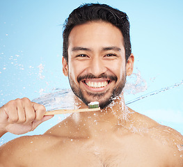 Image showing Water splash, portrait or man brushing teeth in studio with toothbrush for white teeth or oral healthcare. Face, tooth paste or happy person cleaning or washing mouth with a healthy dental smile