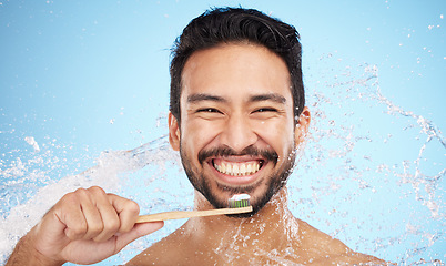 Image showing Water splash, portrait or man brushing teeth in studio with toothbrush for white teeth or oral healthcare. Face, tooth paste or happy person cleaning or washing mouth with a healthy dental smile