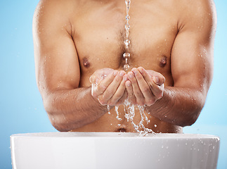 Image showing Man, water or washing hands on blue background for body hygiene maintenance, healthcare wellness or skincare grooming routine. Model, water splash or running shower for cleaning bacteria or self care