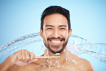 Image showing Water splash, portrait or man brushing teeth in studio with toothbrush for white teeth or oral healthcare. Face, tooth paste or happy person cleaning or washing mouth with a healthy dental smile
