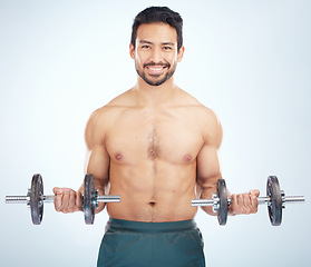 Image showing Portrait, fitness or man training with dumbbell in workout or exercise in studio for strong arms, biceps or body goals. Muscles, mindset or happy bodybuilder sports athlete weightlifting with mock up