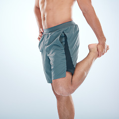 Image showing Fitness, health and man stretching leg in studio isolated on a blue background mock up. Sports, body wellness and young male athlete stretch, warm up and preparing for workout, exercise and training.