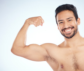 Image showing Portrait, fitness or man in studio to flex muscle or strong arms training biceps in workout or exercise. Face, happy smile or healthy bodybuilder with growth mindset, motivation or wellness goals