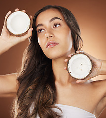 Image showing Coconut skincare beauty, woman and studio for health, wellness and natural radiant glow by backdrop. Model, face and fruit for nutrition, cosmetics or coconut oil for skin moisturizer by background