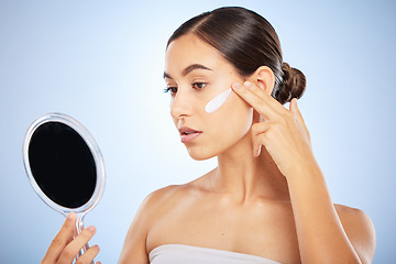 Image showing Mirror, face or woman with skincare cream for beauty or sunscreen protection in grooming morning routine in studio. Wellness, dermatology or girl model applying facial lotion or cosmetics product