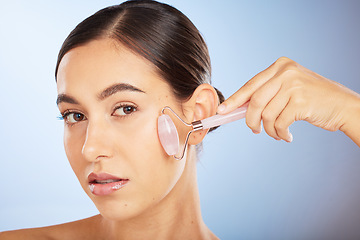 Image showing Beauty, portrait or woman with a roller for skincare in facial grooming routine in studio with advertising mockup space. Product, luxury or girl model with cosmetics, natural glowing or smooth face