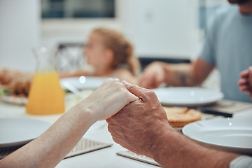 Image showing Family, holding hands and praying for lunch in home dining room table. Gratitude, faith and prayer, worship or thanksgiving of parents, grandparents and children before eating food, brunch or buffet.
