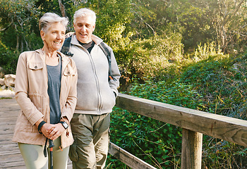 Image showing Senior hiking couple, bridge and nature on outdoor adventure, summer sunshine or bonding together. Elderly man, old woman and happiness with smile, love or walking in woods, forest or park for health