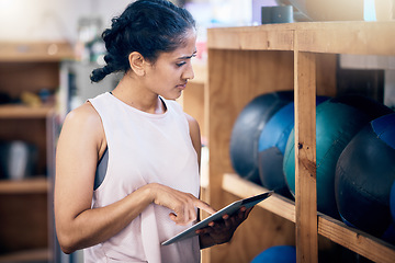 Image showing Woman, gym and tablet for equipment inspection, or and balls for training, workout or exercise. Fitness club manager, digital tech planning or personal trainer for wellness management in workplace