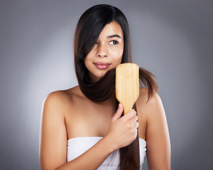 Image showing Woman, brush and hair care for beauty, wellness and self care by studio background with natural shine. Model, hair and self love with organic wooden hairbrush for sustainable cosmetics by backdrop