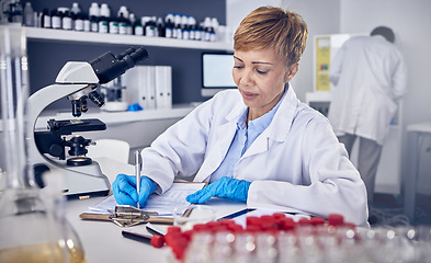 Image showing Senior black woman, research or scientist writing a science report in a laboratory for medical data analysis. Healthcare, focus or doctor working on chemistry paperwork, documents or development